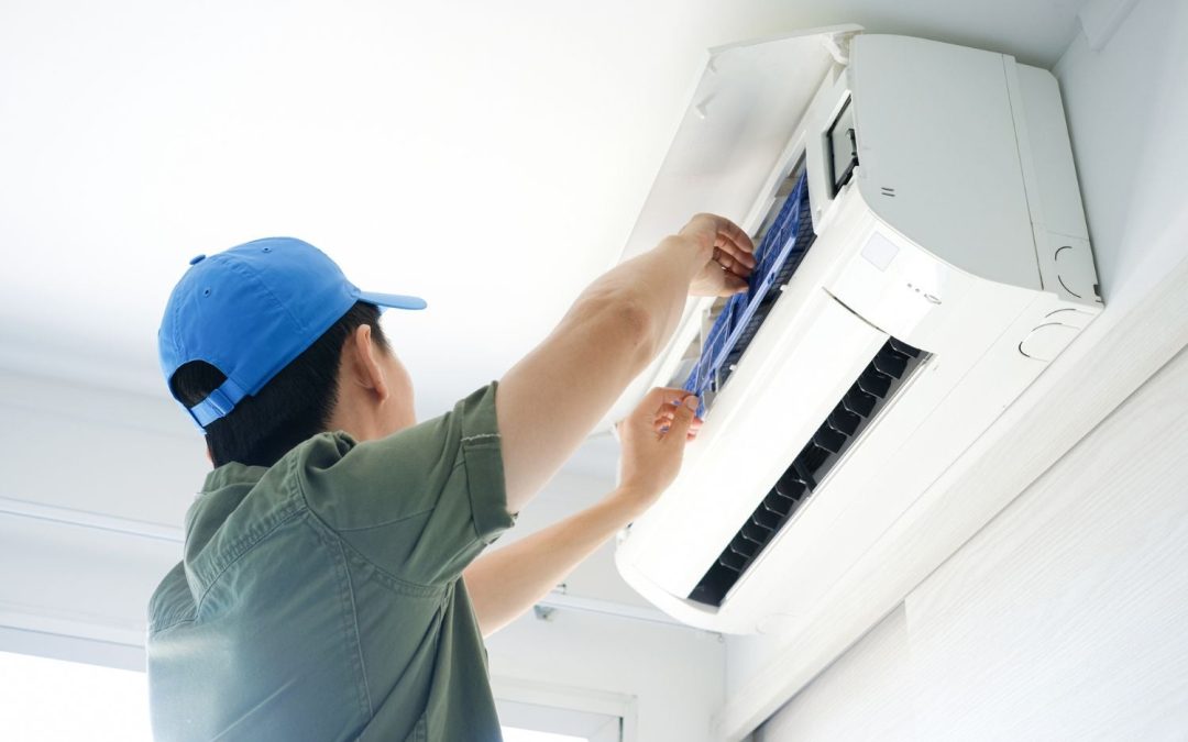 Air conditioning technician maintaining an indoor mini split system in Windsor, CO