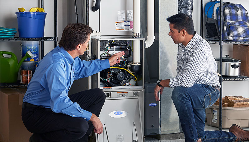 HVAC technician evaluating a furnace for repair or replacement in Windsor
