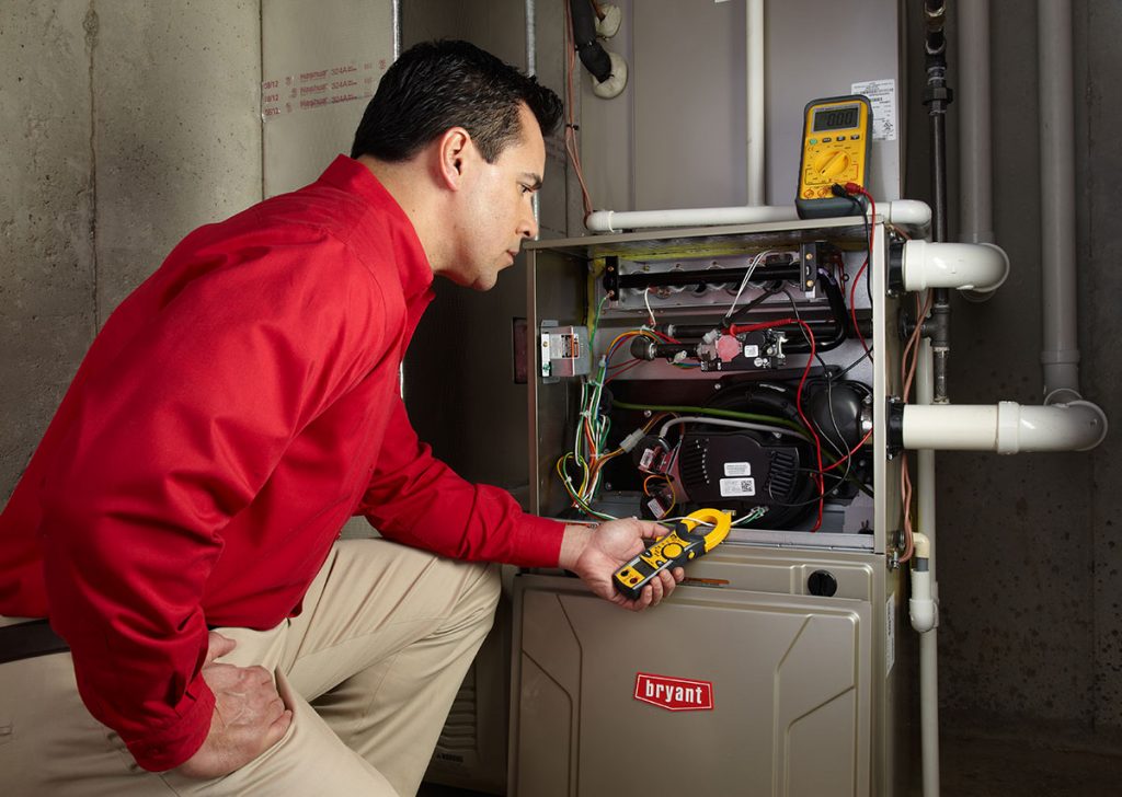 HVAC technician repairing an indoor furnace in Windsor